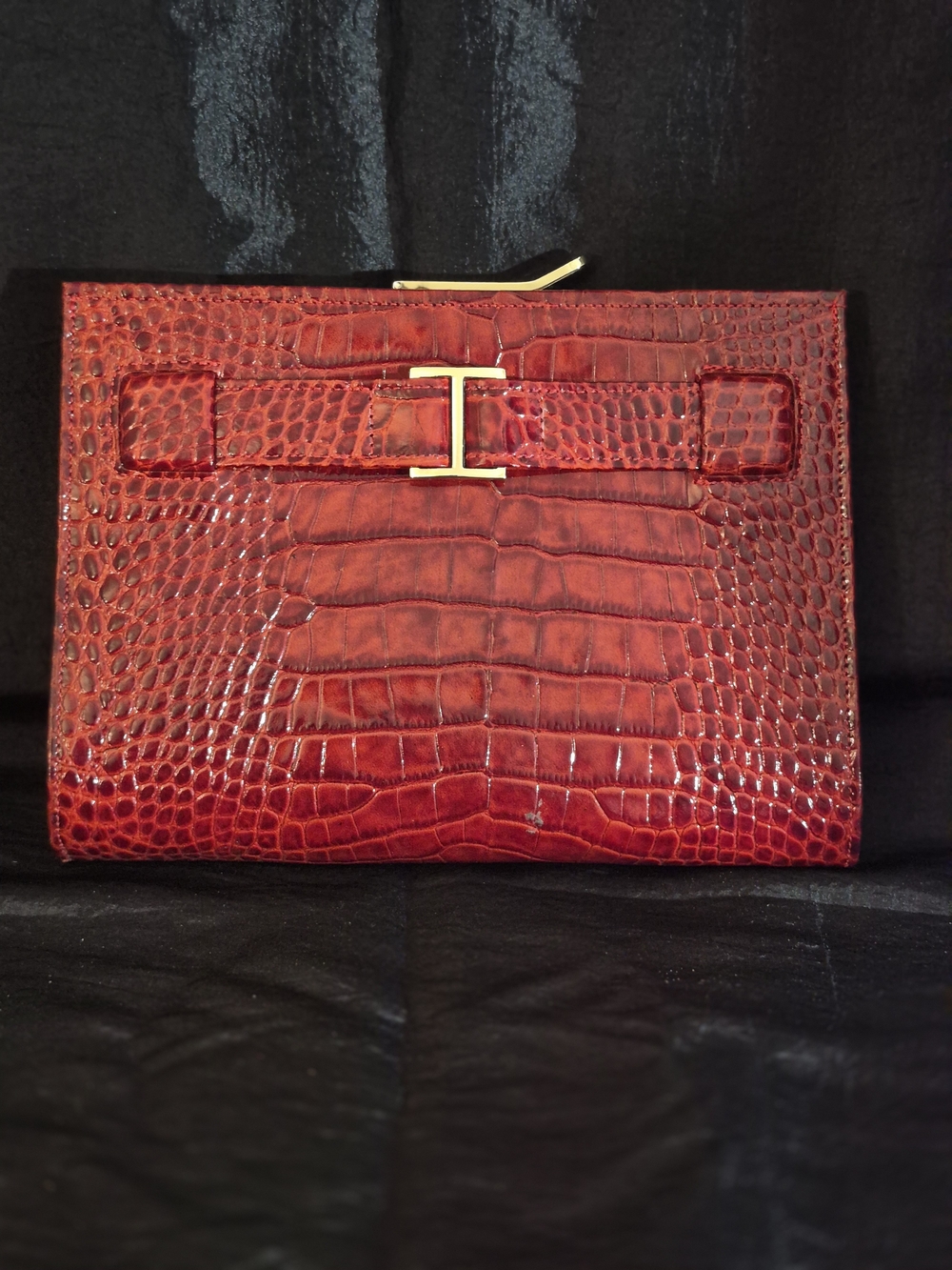 Abas croc-embossed leather clutch with distinctive gold-tone "H" buckle